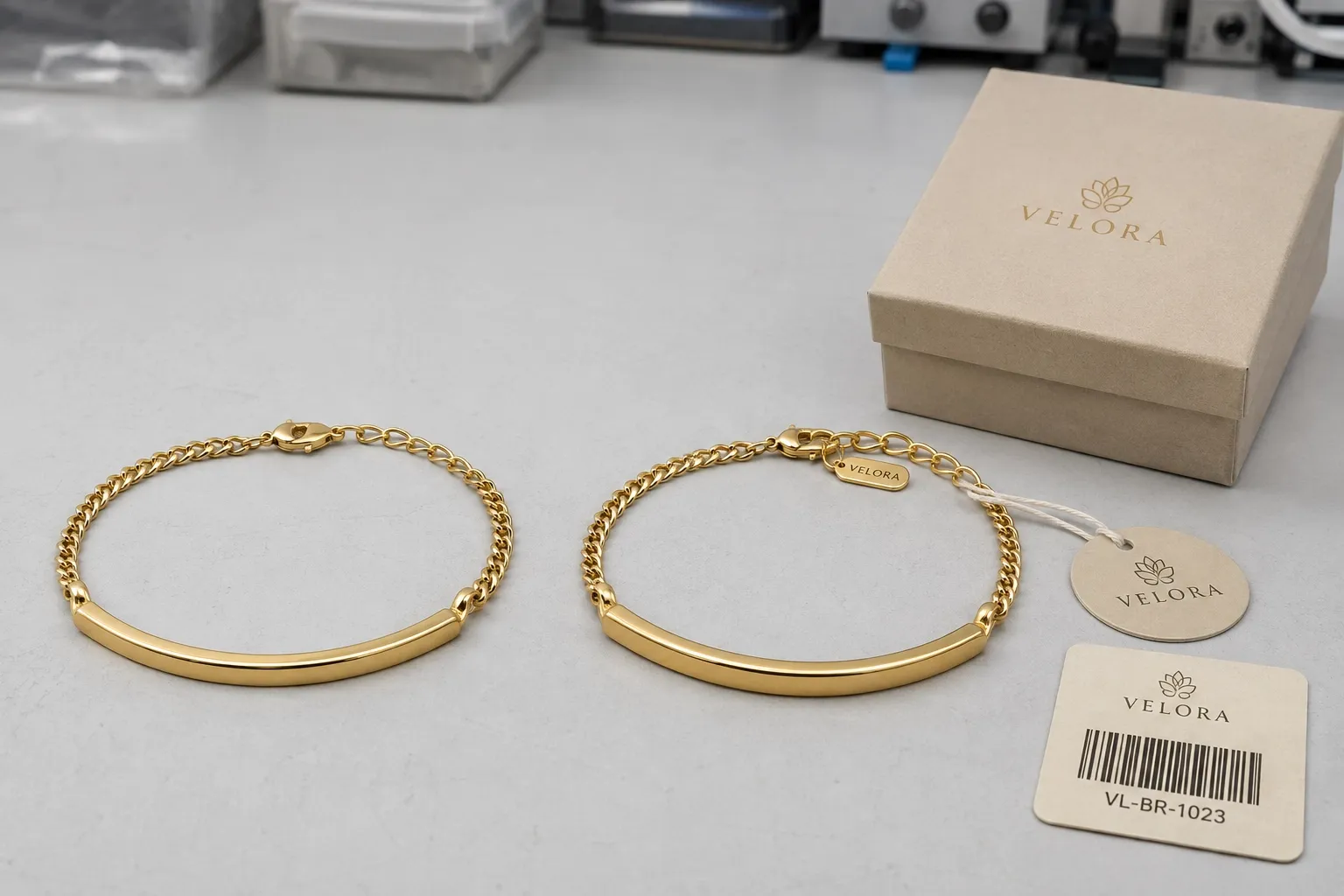 What private label gives you — The same production piece plain, then with the branding applied — engraved mark, branded clasp tag, printed box and barcode card